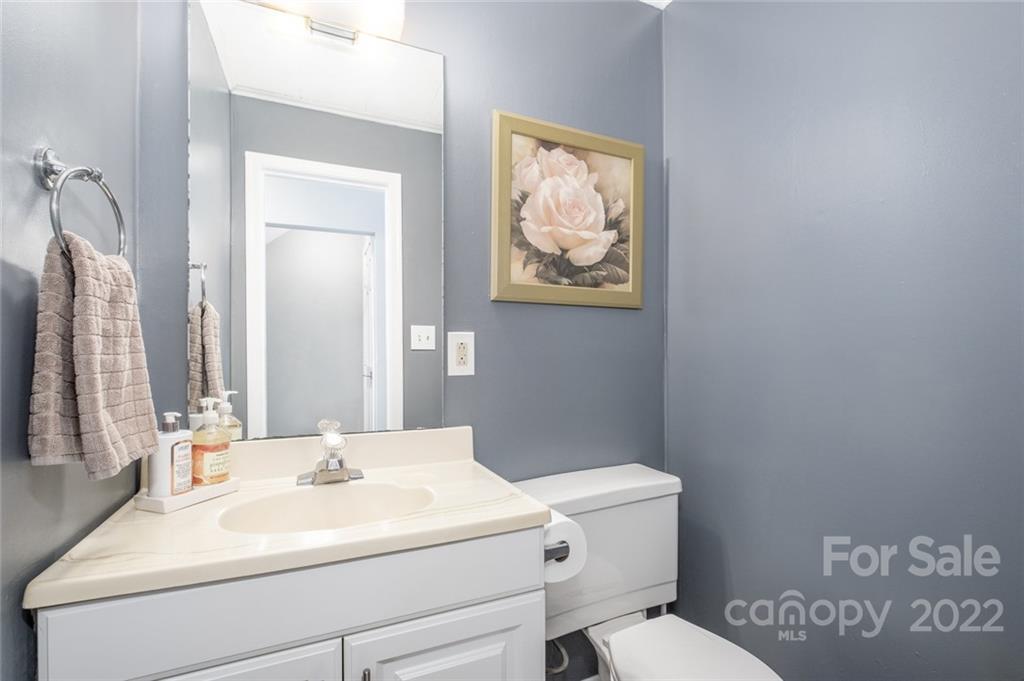 8346 Knights Bridge Road Charlotte, NC 28210 - Photo 9 of 29 a bathroom with a sink mirror vanity and toilet