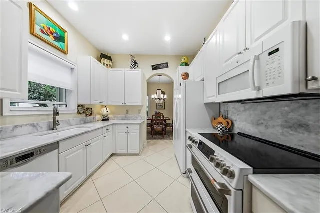 a kitchen with stainless steel appliances granite countertop a sink and cabinets