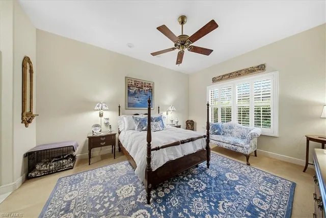 a bedroom with a bed a couch and a window