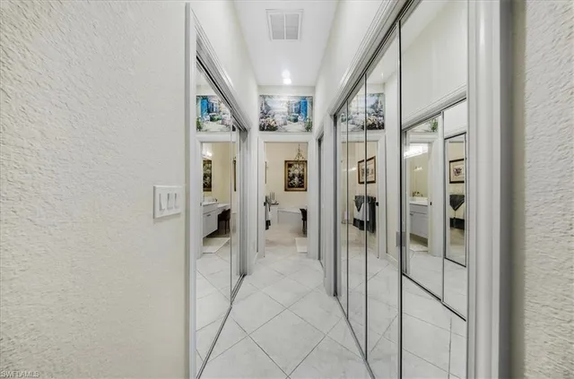 a view of a hallway with wooden shelves