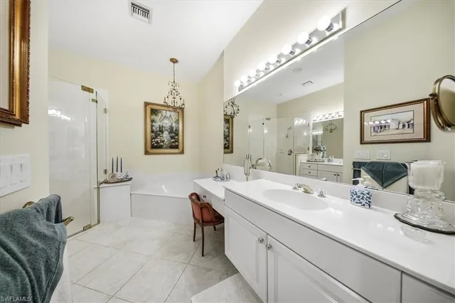 a spacious bathroom with a double vanity sink a mirror and shower
