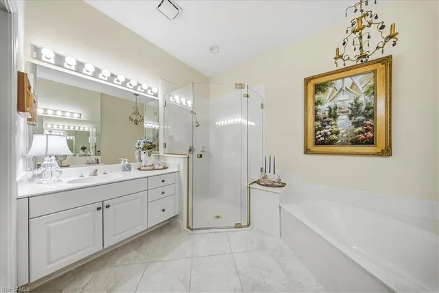 a spacious bathroom with a double vanity sink a mirror and a bathtub