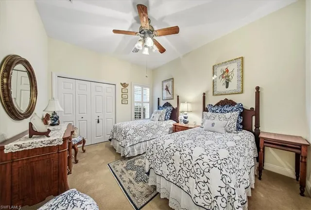 a bedroom with a bed a dresser with wooden floor