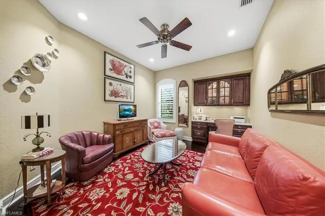 a living room with furniture kitchen view and a window