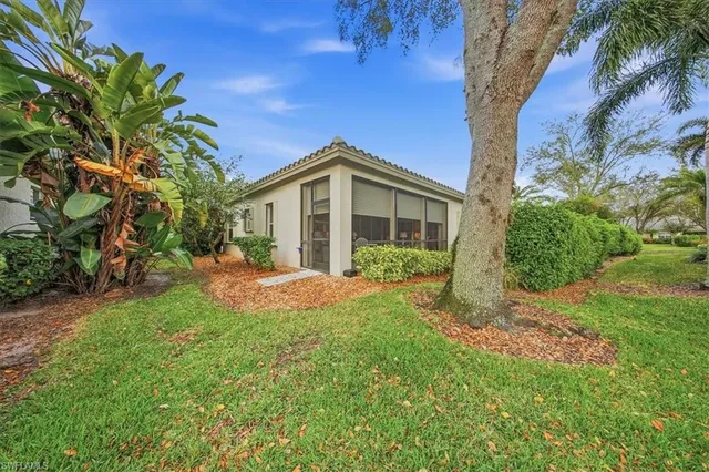 a front view of a house with a yard and a garage