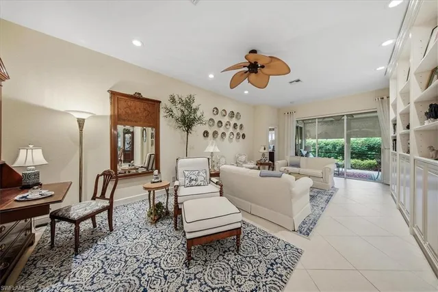 a living room with furniture a rug and white walls