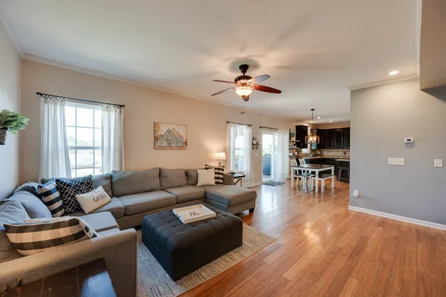 a living room with furniture and wooden floor