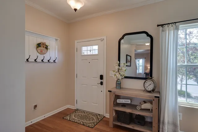 a view of an entryway with wooden floor