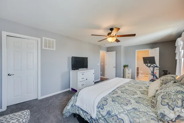 a bedroom with a bed and a tv