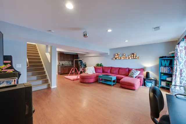 a living room with furniture and a book shelf
