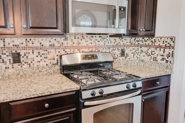 a stove top oven sitting inside of a kitchen