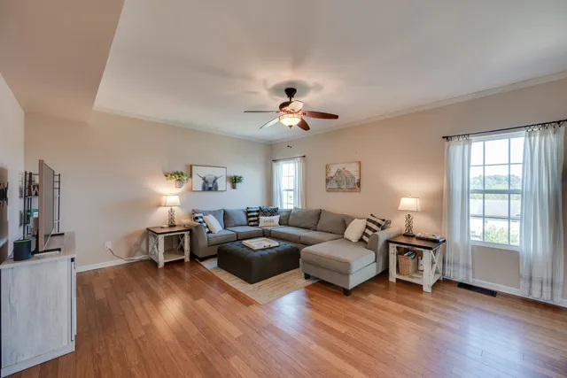 a living room with furniture window and wooden floor