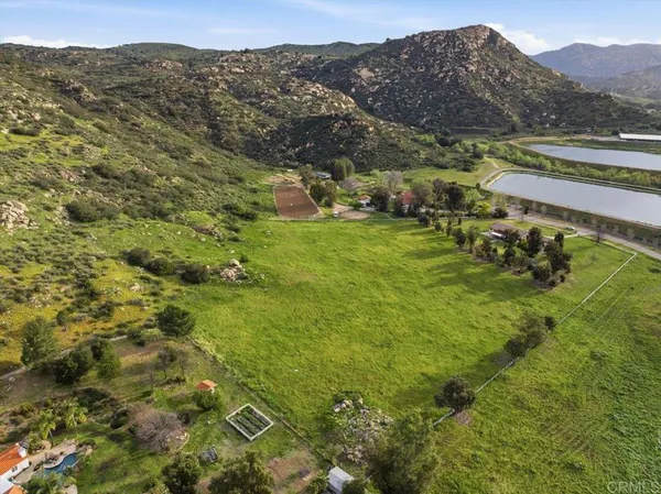 a view of a lush green hillside and houses