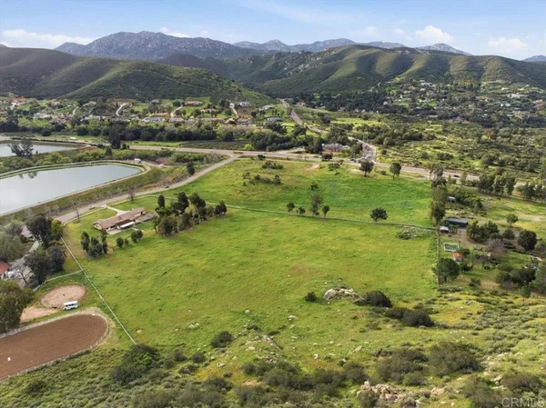 a view of a lush green hillside and houses