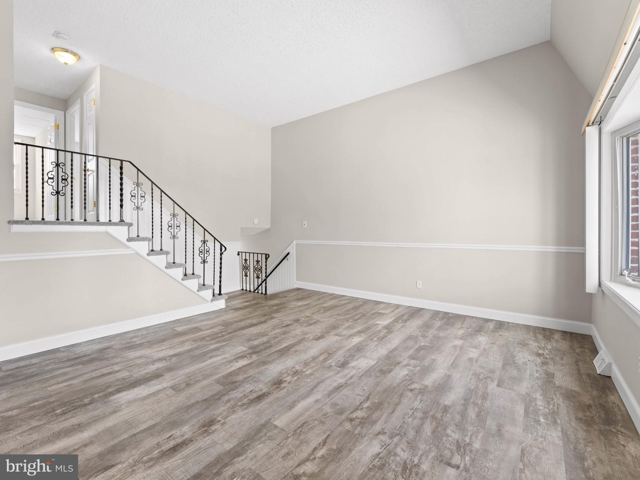 111 Ervin Avenue Marcus Hook, PA 19061 - Photo 5 of 37 a view of an empty room with wooden floor and fan