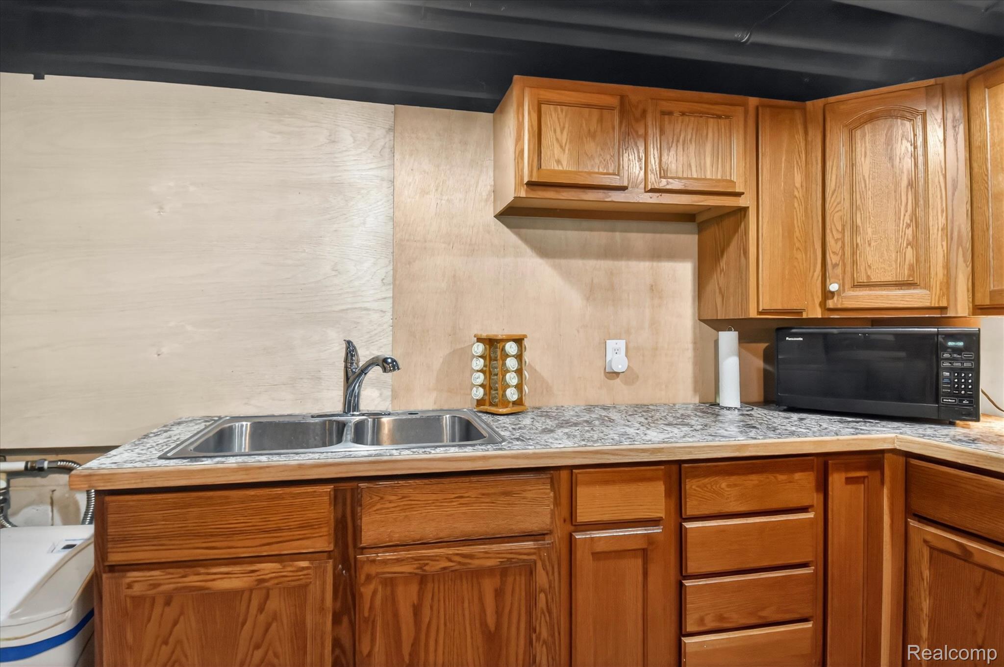 3949 West Burns Line Road Brown City, MI 48416 - Photo 48 of 70 Kitchenette featuring wood cabinetry, laminate countertops, and a double basin stainless steel sink with a chrome faucet