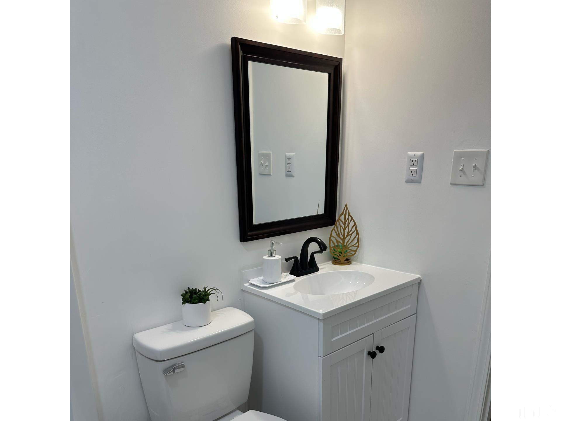 216 Trinity Church Road Louisburg, NC 27549 - Photo 24 of 28 a bathroom with a toilet sink and mirror