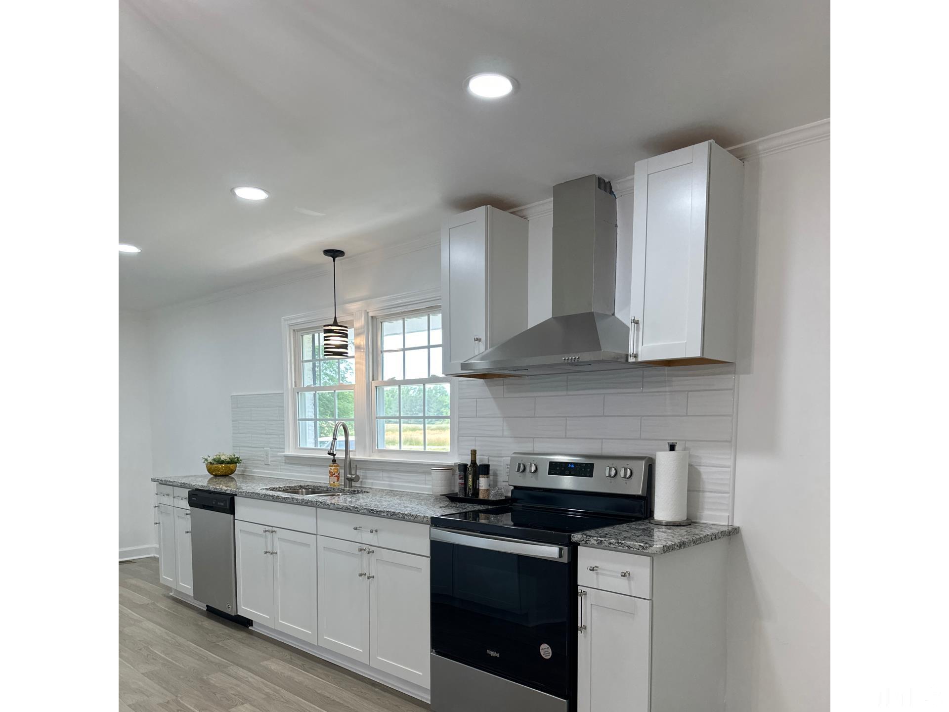 216 Trinity Church Road Louisburg, NC 27549 - Photo 4 of 28 a kitchen with stainless steel appliances granite countertop a sink stove and cabinets