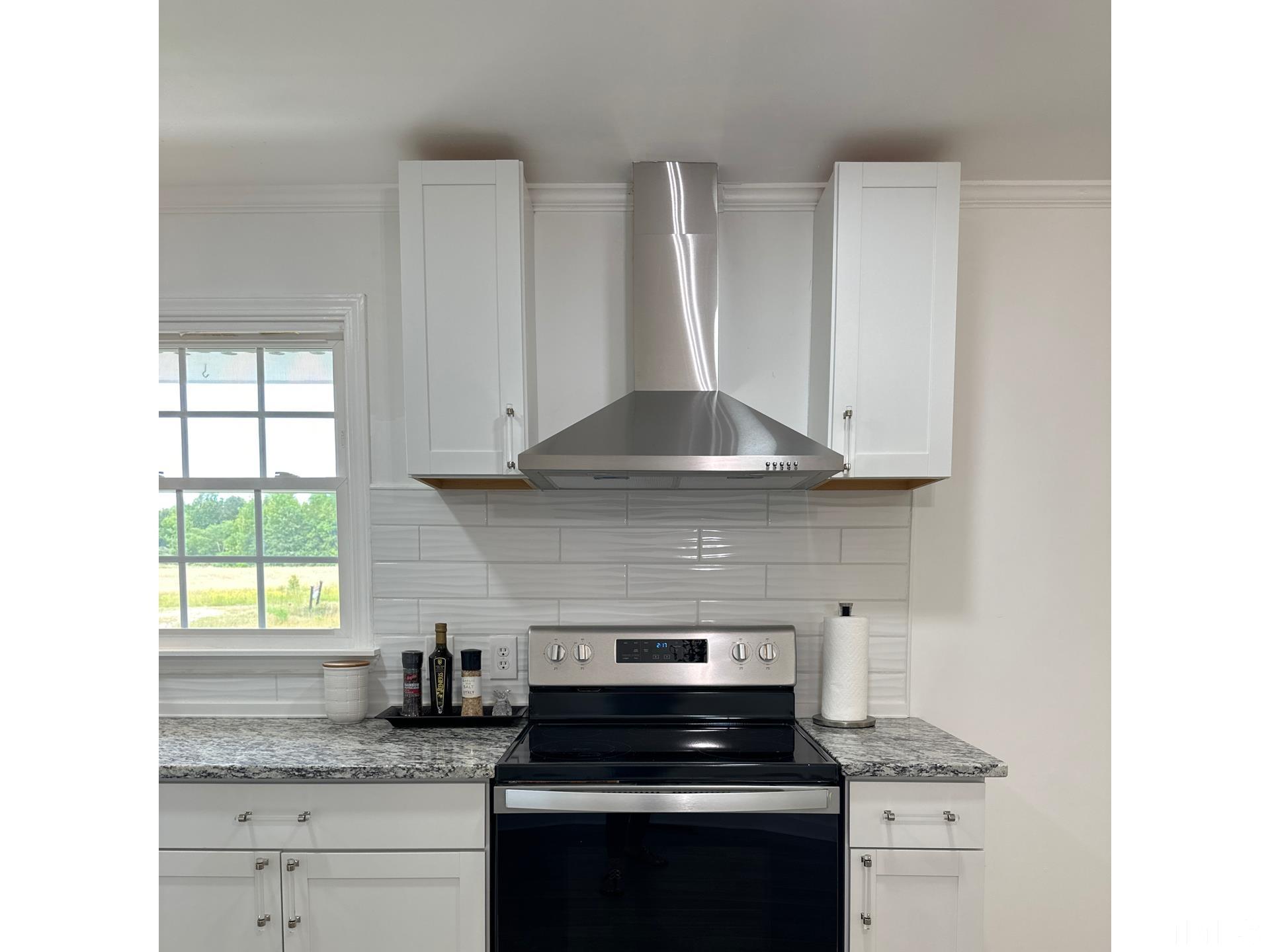 216 Trinity Church Road Louisburg, NC 27549 - Photo 7 of 28 a stove top oven sitting inside of a kitchen