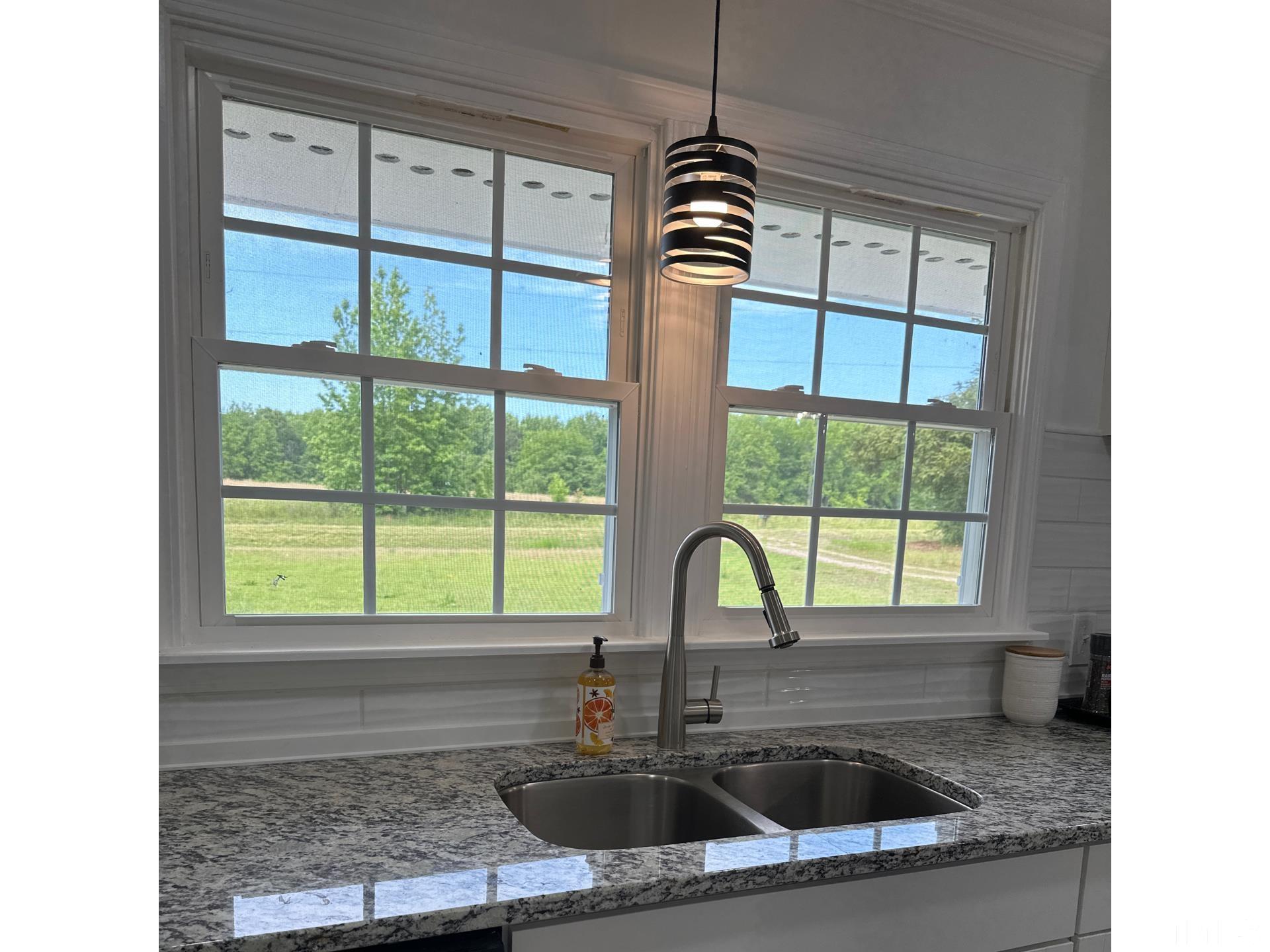 216 Trinity Church Road Louisburg, NC 27549 - Photo 8 of 28 a kitchen with a sink a counter top and outdoor space