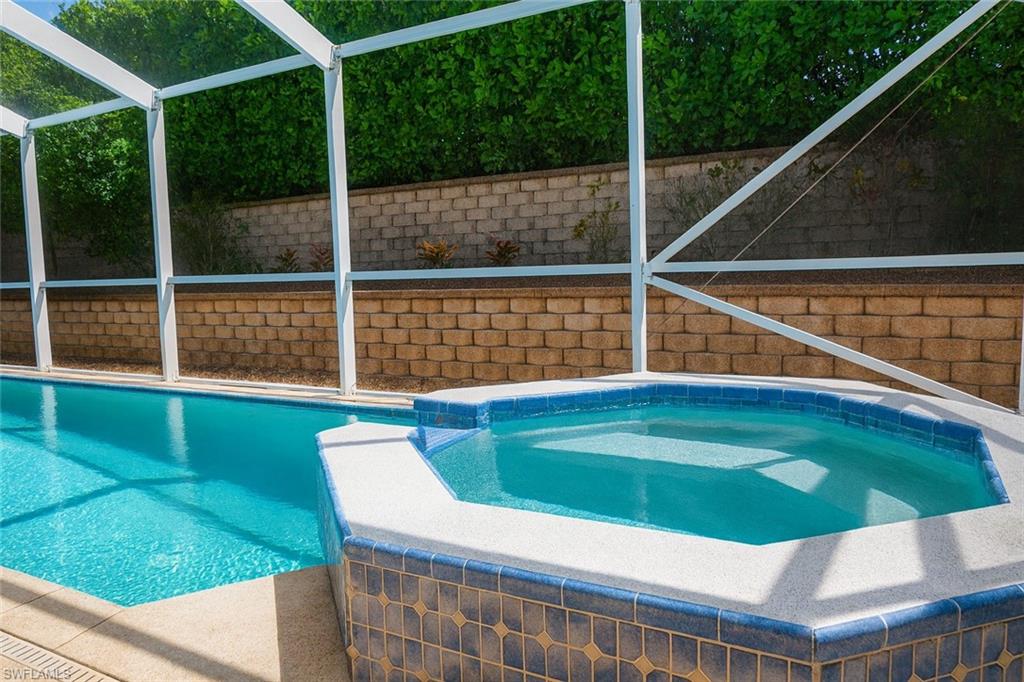1975 San Marco Road Marco Island, FL 34145 - Photo 14 of 46 Outdoor pool with an in-ground hot tub and glass enclosure