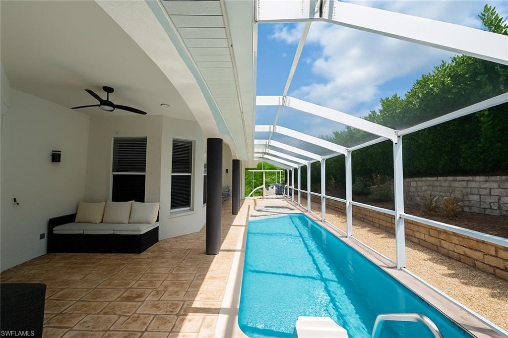 1975 San Marco Road Marco Island, FL 34145 - Photo 15 of 46 Outdoor pool with a sunroom, a patio area, a ceiling fan, and a lanai