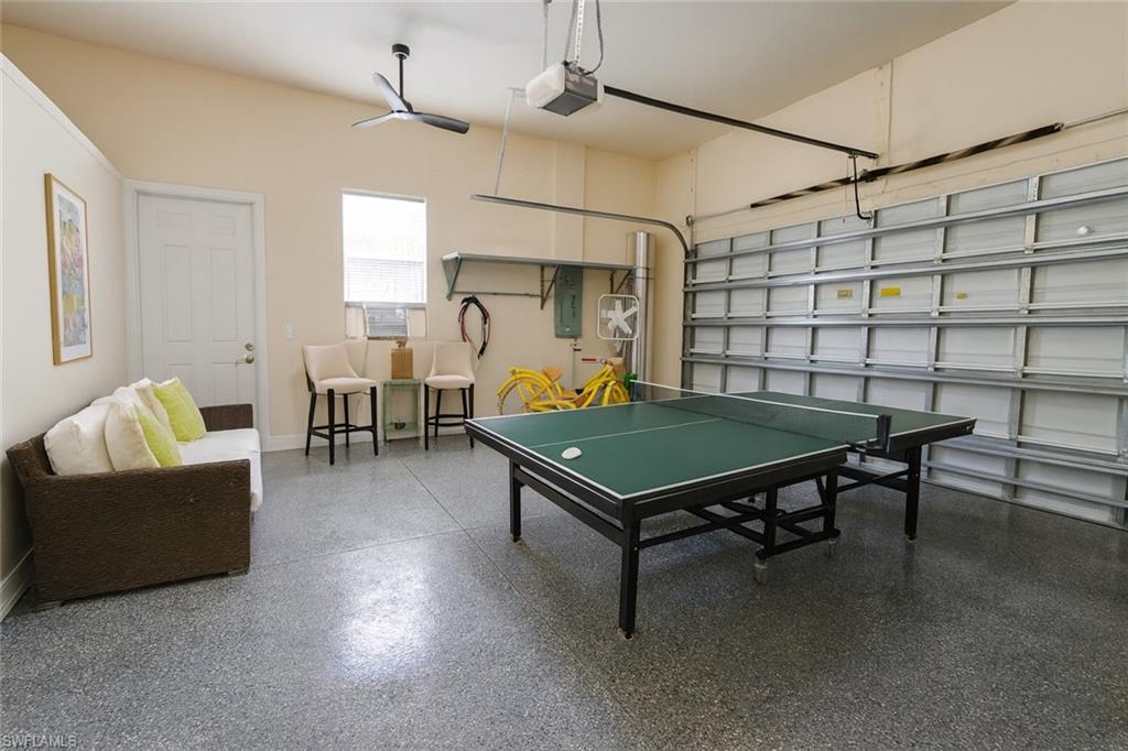 1975 San Marco Road Marco Island, FL 34145 - Photo 28 of 46 Rec room featuring a garage, electric panel, and speckled floor