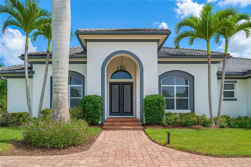 1975 San Marco Road Marco Island, FL 34145 - Photo 3 of 46 View of exterior entry with stucco siding and a tile roof