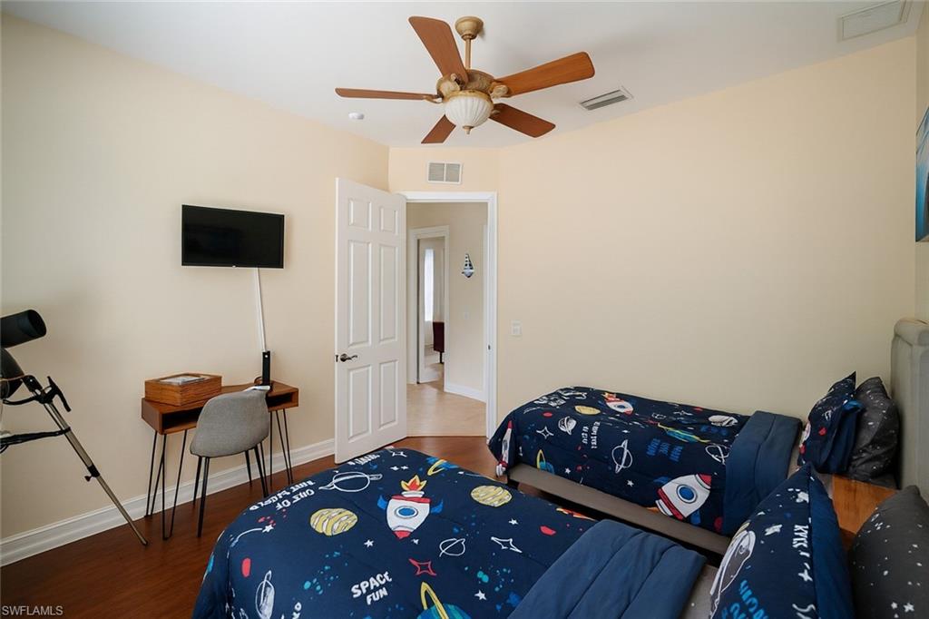 1975 San Marco Road Marco Island, FL 34145 - Photo 37 of 46 Bedroom featuring dark wood-type flooring and a ceiling fan