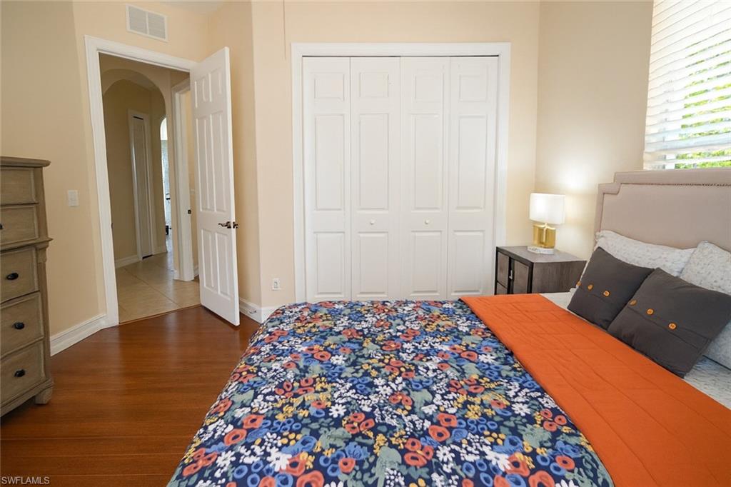 1975 San Marco Road Marco Island, FL 34145 - Photo 39 of 46 Bedroom with dark wood finished floors, arched walkways, and a closet