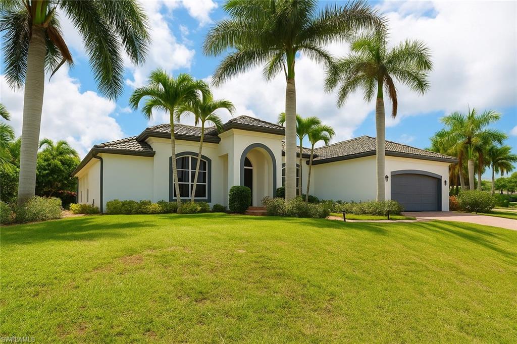 1975 San Marco Road Marco Island, FL 34145 - Photo 4 of 46 Mediterranean / spanish house with a garage, a front lawn, and stucco siding