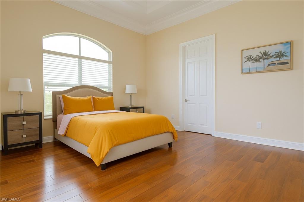 1975 San Marco Road Marco Island, FL 34145 - Photo 42 of 46 Bedroom with wood finished floors and crown molding