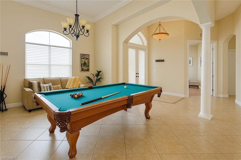 1975 San Marco Road Marco Island, FL 34145 - Photo 44 of 46 Playroom with arched walkways, french doors, plenty of natural light, and ornamental molding