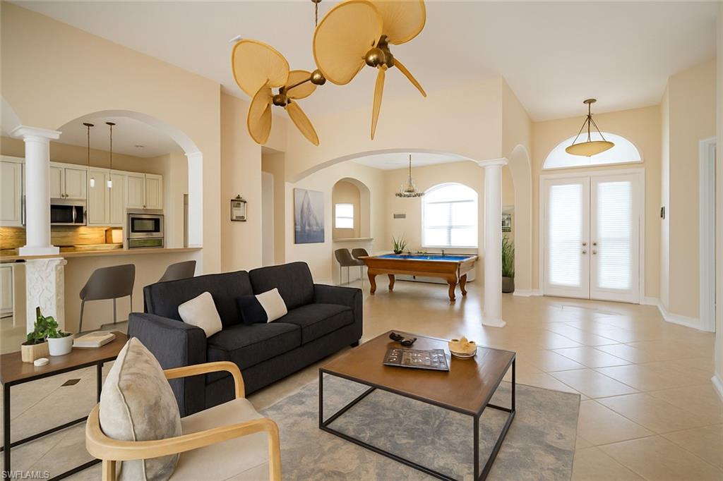 1975 San Marco Road Marco Island, FL 34145 - Photo 45 of 46 Living room featuring light tile patterned flooring, arched walkways, french doors, and billiards table
