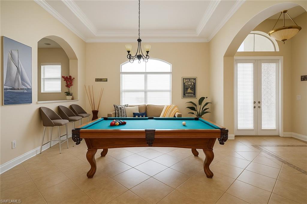 1975 San Marco Road Marco Island, FL 34145 - Photo 46 of 46 Playroom featuring light tile patterned flooring, crown molding, pool table, french doors, and arched walkways