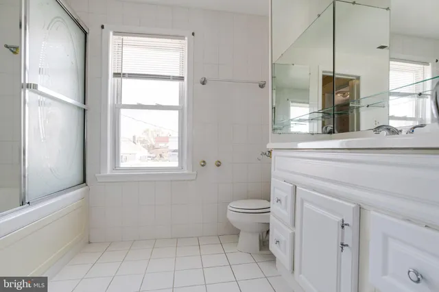 a bathroom with a toilet sink and a mirror