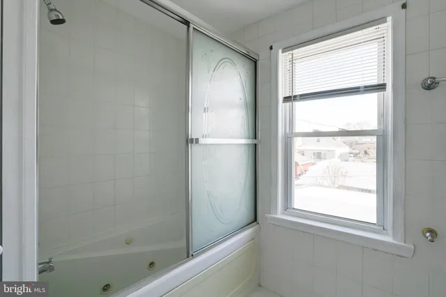 a bathroom with a bathtub and a shower