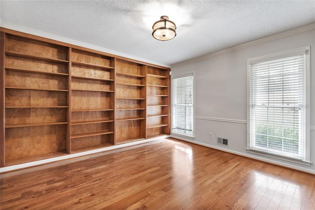 4803 Tarleton Drive Southwest Lilburn, GA 30047 - Photo 11 of 32 a view of an empty room with a window and wooden floor