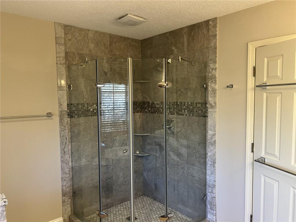 4803 Tarleton Drive Southwest Lilburn, GA 30047 - Photo 16 of 32 a bathroom with a shower