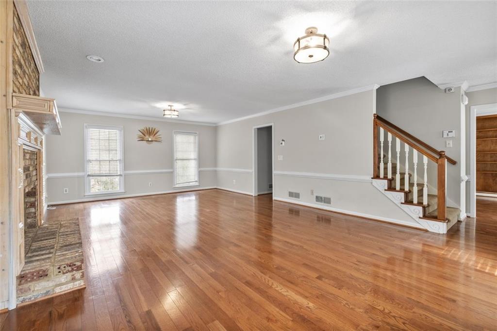 4803 Tarleton Drive Southwest Lilburn, GA 30047 - Photo 4 of 32 wooden floor in an empty room with a window