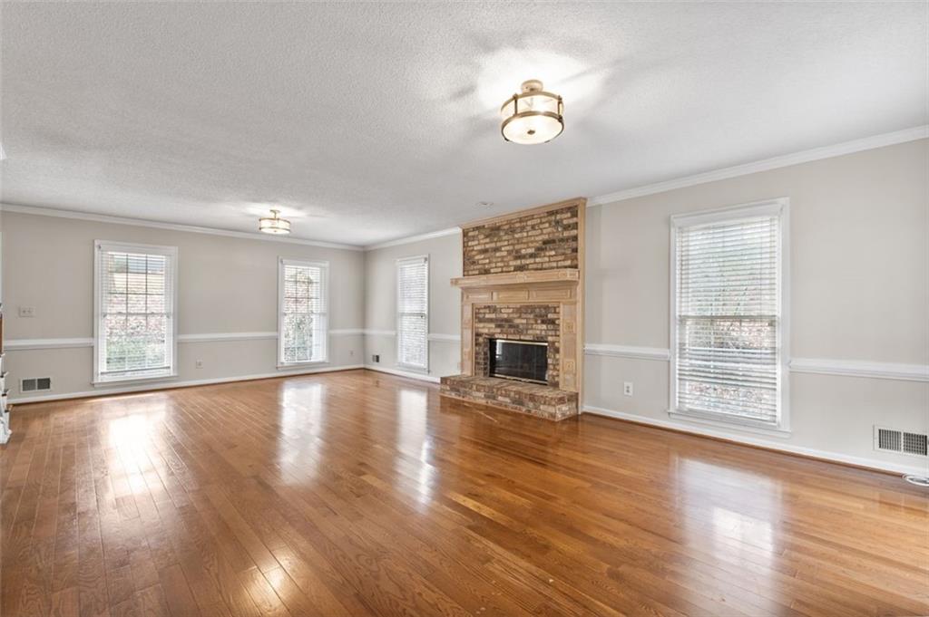 4803 Tarleton Drive Southwest Lilburn, GA 30047 - Photo 5 of 32 a view of an empty room with wooden floor and a window