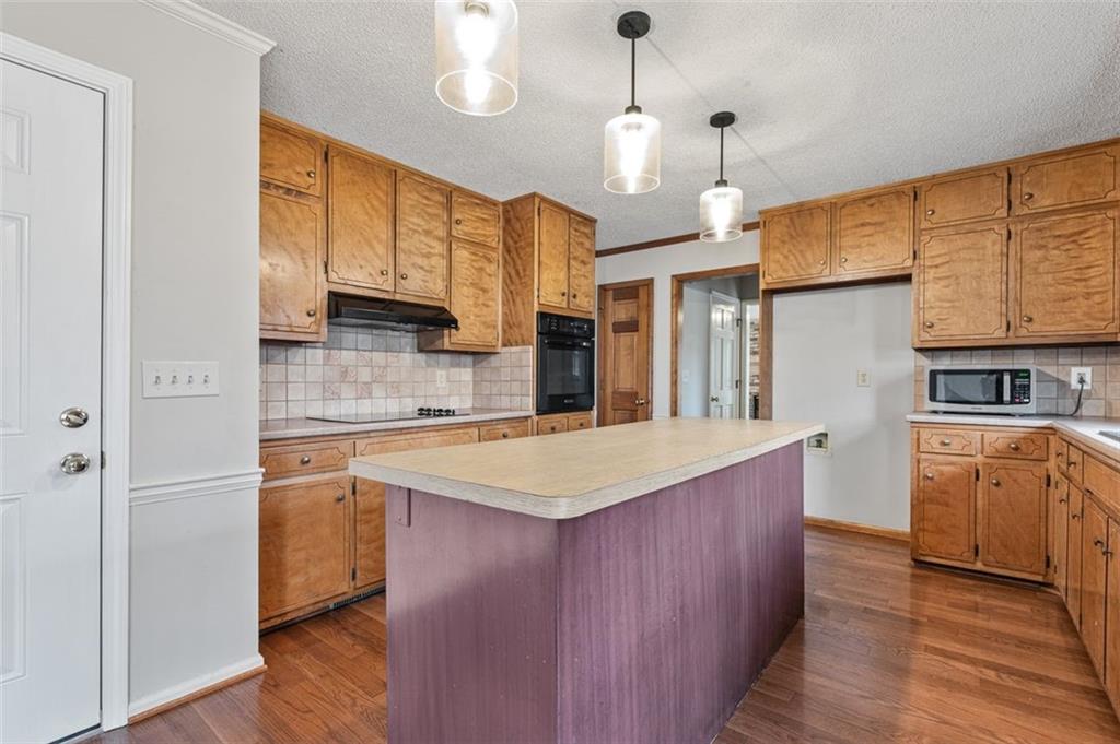 4803 Tarleton Drive Southwest Lilburn, GA 30047 - Photo 6 of 32 a kitchen with stainless steel appliances granite countertop a sink a stove and a refrigerator