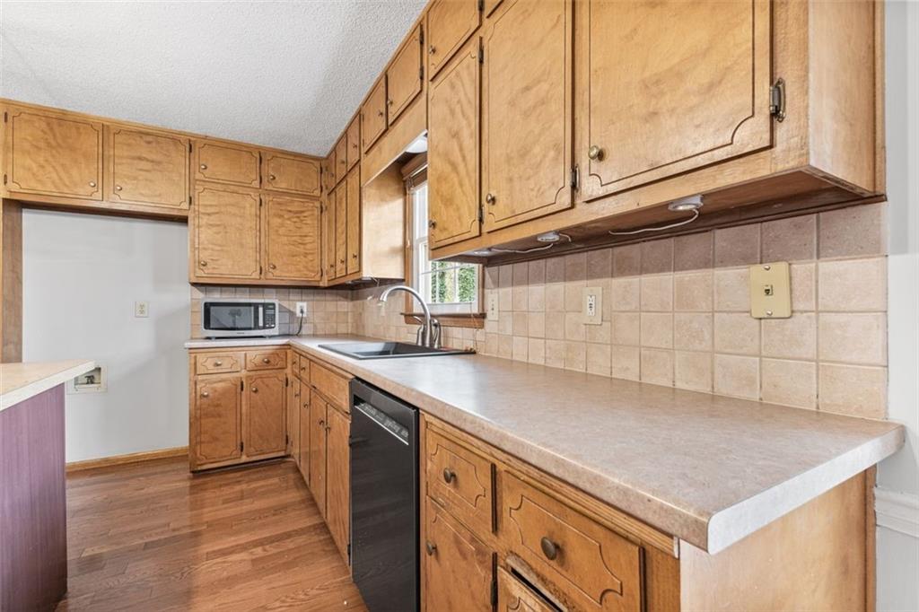 4803 Tarleton Drive Southwest Lilburn, GA 30047 - Photo 7 of 32 a kitchen with stainless steel appliances a sink and a cabinets