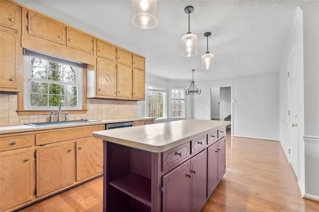 a kitchen with a sink stove and window