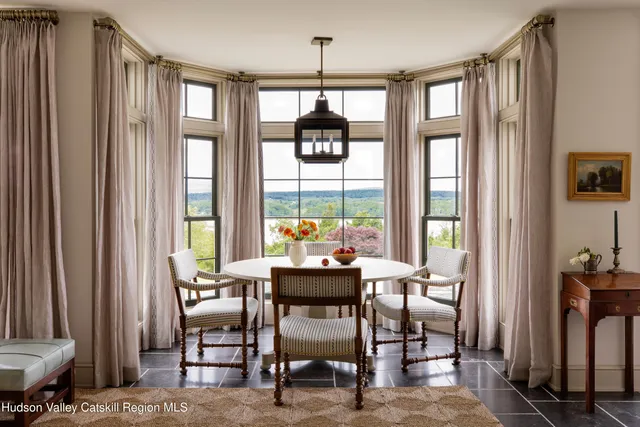 a dining room with furniture and window