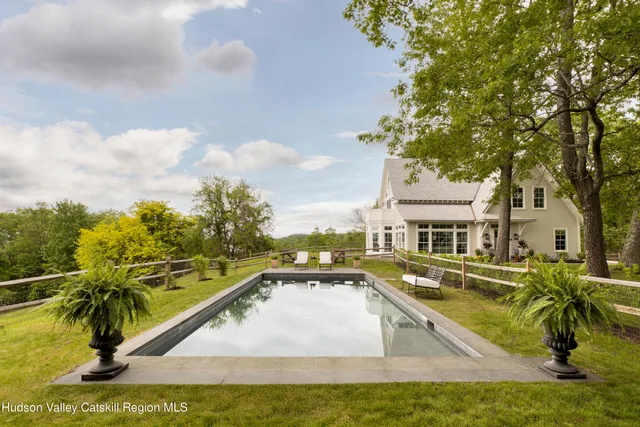 a view of a chair and tables in the back yard of the house