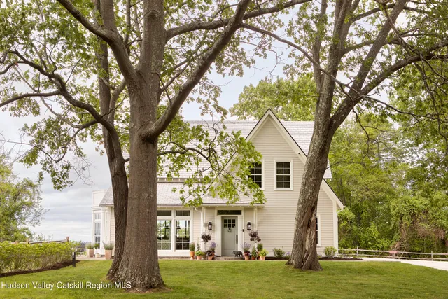 a view of a house with a large tree and a big yard