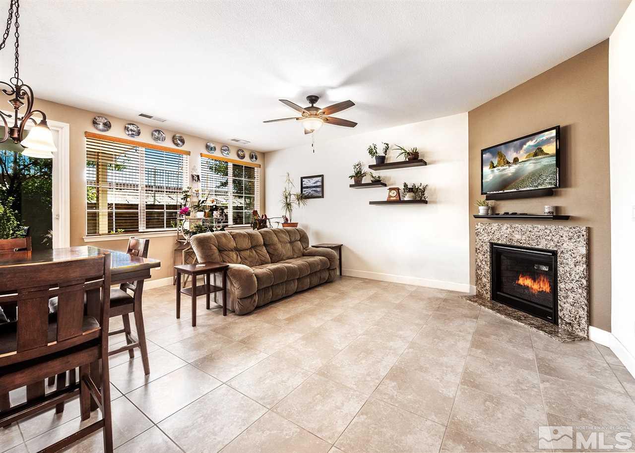 2048 Whitecliff Drive Reno, NV 89521 - Photo 8 of 23 a living room with furniture a fireplace and a flat screen tv