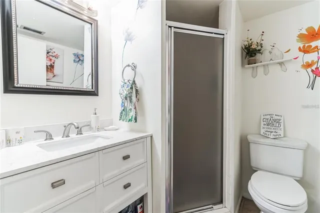 a bathroom with a toilet sink and vanity