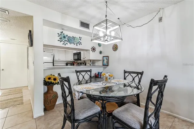 a view of a dining room with furniture and a chandelier